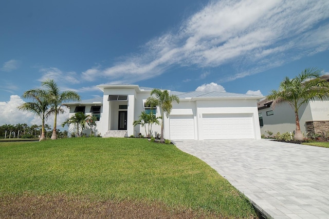 view of front of home with stucco siding, metal roof, decorative driveway, a garage, and a standing seam roof