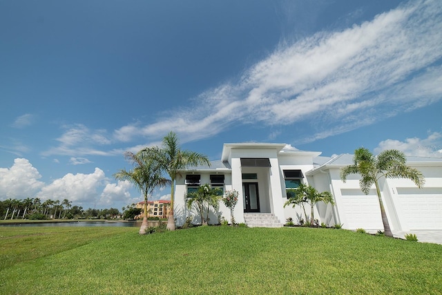 view of front facade with a garage and a front lawn