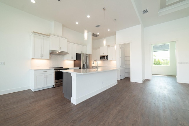 kitchen featuring a center island with sink, white cabinetry, and appliances with stainless steel finishes