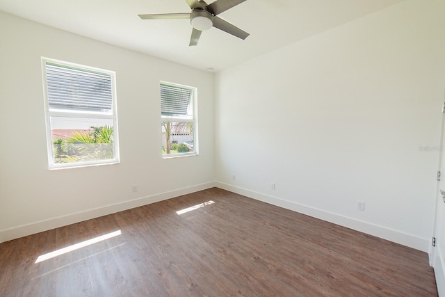 empty room with dark hardwood / wood-style floors and ceiling fan