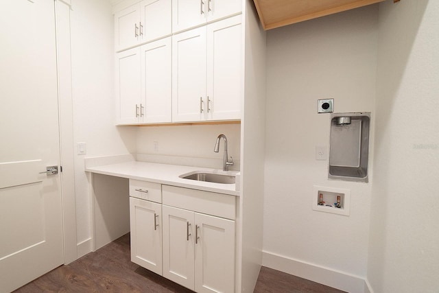 laundry area with cabinets, sink, hookup for a washing machine, dark hardwood / wood-style floors, and hookup for an electric dryer