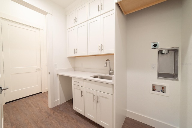 washroom featuring cabinets, washer hookup, electric dryer hookup, sink, and hardwood / wood-style flooring