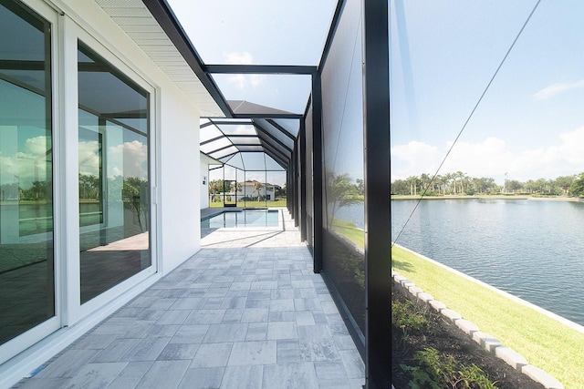 unfurnished sunroom featuring a water view and lofted ceiling