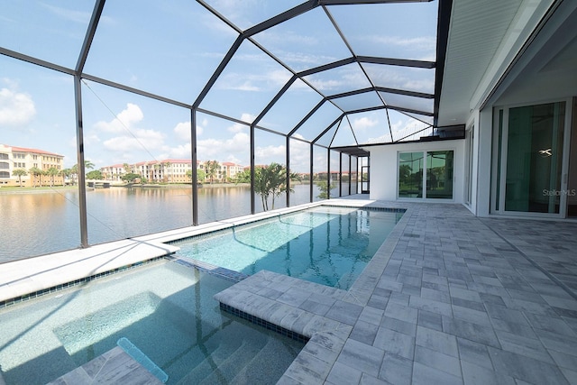 view of swimming pool with a lanai, a patio area, and a water view