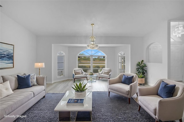 living room with wood-type flooring and an inviting chandelier