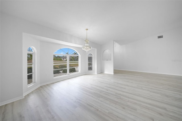 interior space featuring a chandelier and light hardwood / wood-style flooring