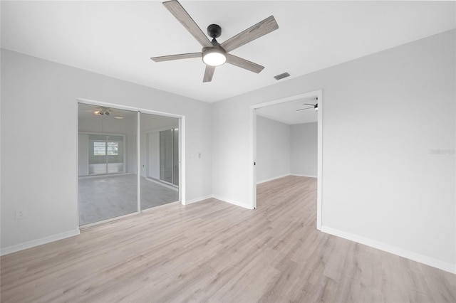 unfurnished room featuring ceiling fan and light wood-type flooring