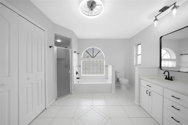 full bathroom with tile patterned flooring, vanity, independent shower and bath, and toilet