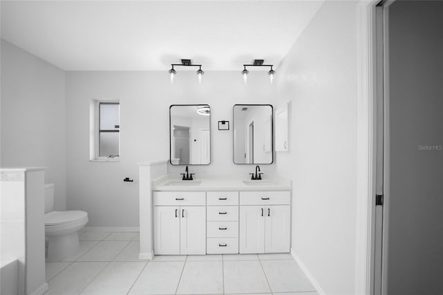 bathroom featuring tile patterned flooring, vanity, and toilet