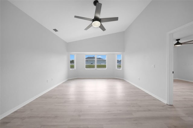 spare room with ceiling fan, light wood-type flooring, and high vaulted ceiling