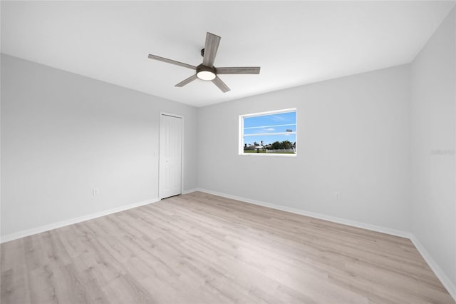 empty room featuring ceiling fan and light hardwood / wood-style flooring