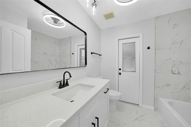 full bathroom featuring vanity, toilet, and tiled shower / bath combo