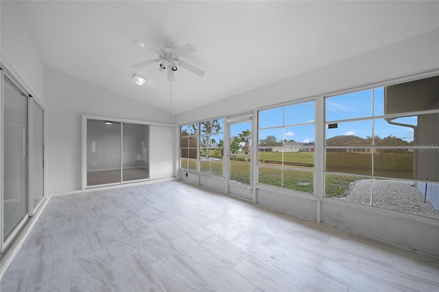 unfurnished sunroom featuring ceiling fan and lofted ceiling