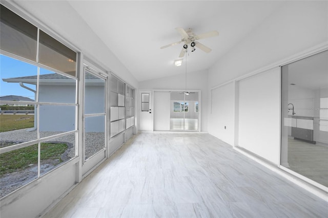 unfurnished sunroom with a wealth of natural light, ceiling fan, and lofted ceiling