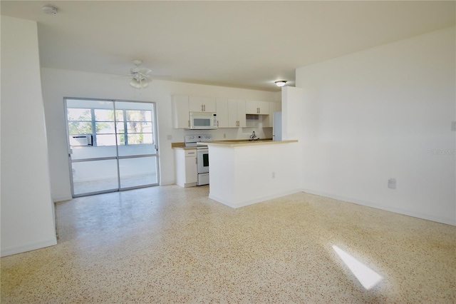 unfurnished living room with ceiling fan and sink