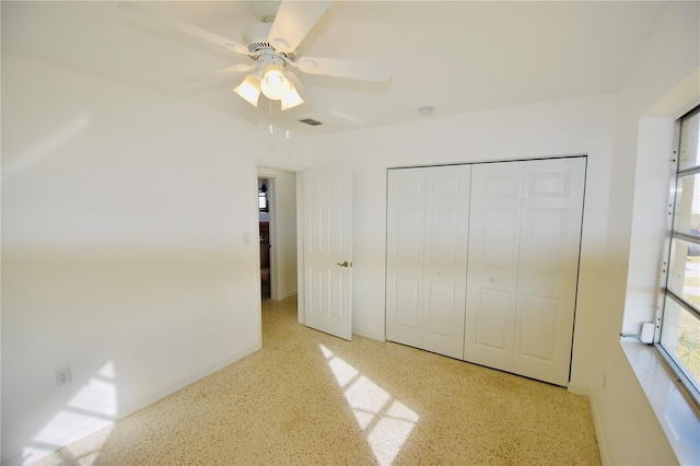 unfurnished bedroom featuring ceiling fan and a closet