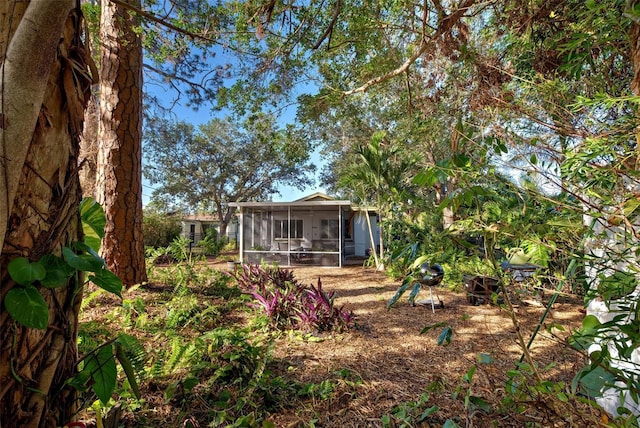 rear view of property featuring a sunroom