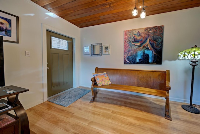 entryway featuring light hardwood / wood-style floors, an inviting chandelier, and wood ceiling