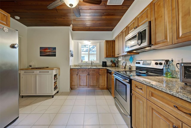 kitchen featuring light tile patterned floors, light stone countertops, wooden ceiling, and appliances with stainless steel finishes