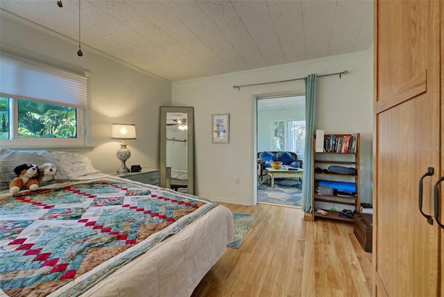 bedroom with light hardwood / wood-style flooring and ornamental molding