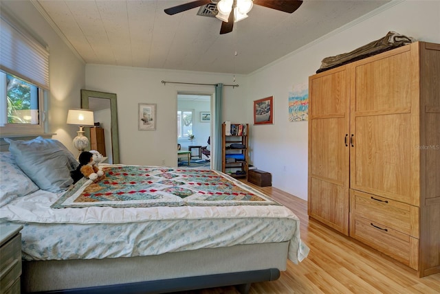 bedroom featuring multiple windows, light hardwood / wood-style flooring, ceiling fan, and crown molding