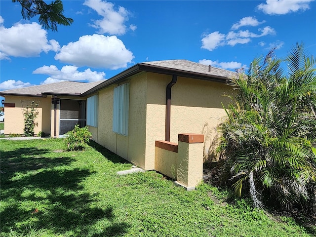 13278 Carter Ave, Port Charlotte, FL 33981 - view of side of property featuring a lawn and stucco siding