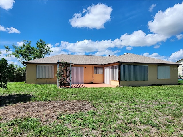 13278 Carter Ave, Port Charlotte, FL 33981 - rear view of property featuring a patio, a yard, and stucco siding