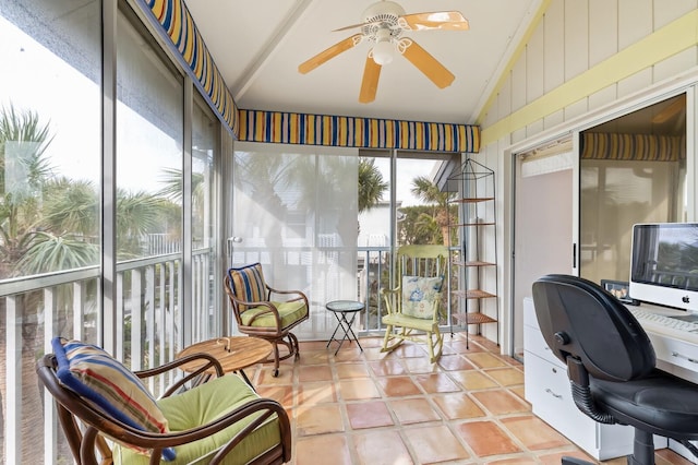 home office featuring ceiling fan, light tile patterned floors, and lofted ceiling