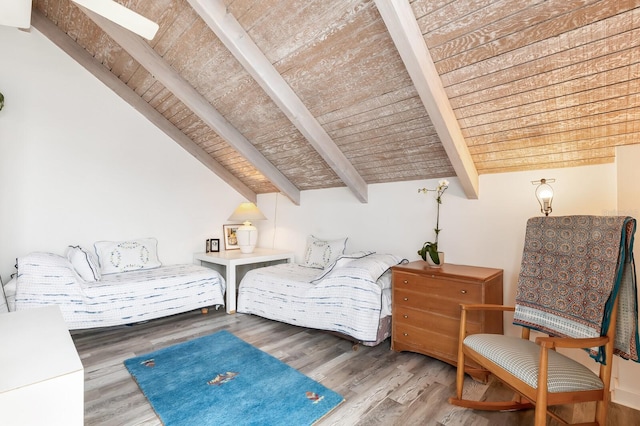 sitting room with wooden ceiling, hardwood / wood-style floors, and lofted ceiling with beams