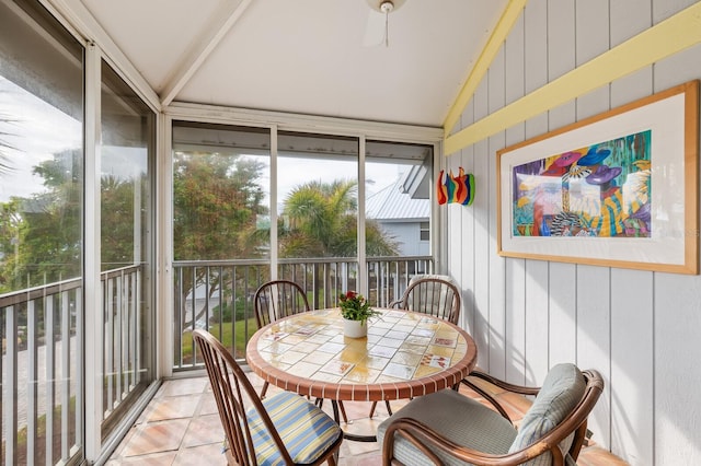 sunroom / solarium featuring vaulted ceiling