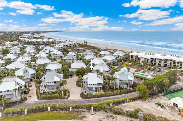 drone / aerial view with a water view and a view of the beach