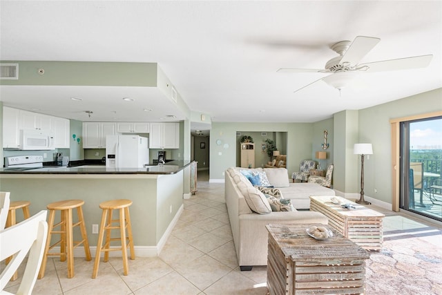 tiled living room featuring ceiling fan