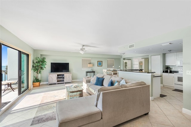 tiled living room with ceiling fan