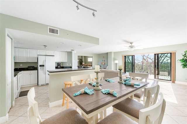 dining area with ceiling fan and light tile patterned flooring