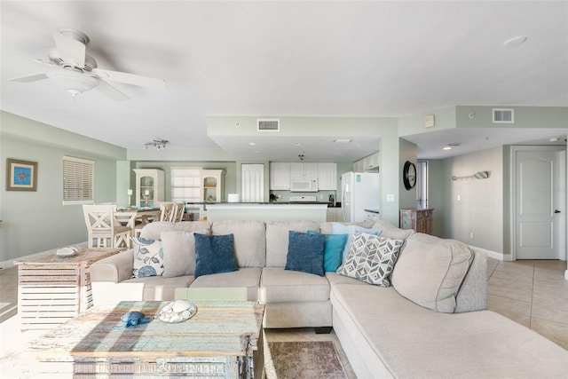 living room with ceiling fan and light tile patterned flooring