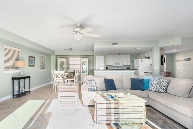 living room featuring ceiling fan and light tile patterned floors