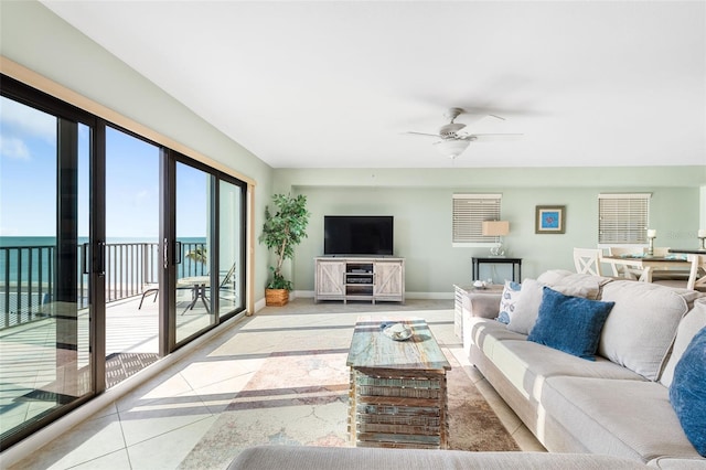 living room featuring ceiling fan and light tile patterned floors