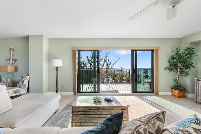 tiled living room with ceiling fan and plenty of natural light