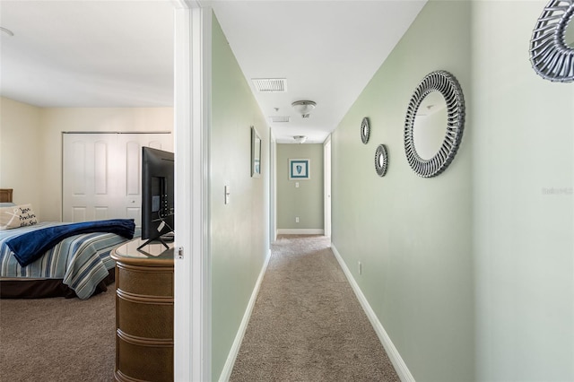 hall featuring light colored carpet