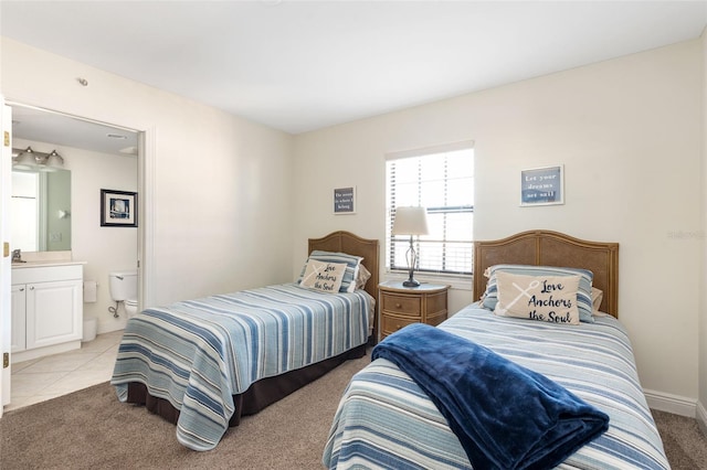 bedroom with sink, connected bathroom, and light colored carpet