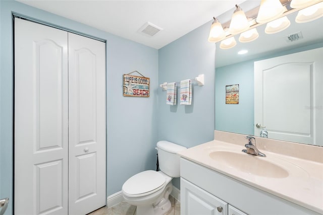 bathroom featuring toilet, tile patterned floors, and vanity