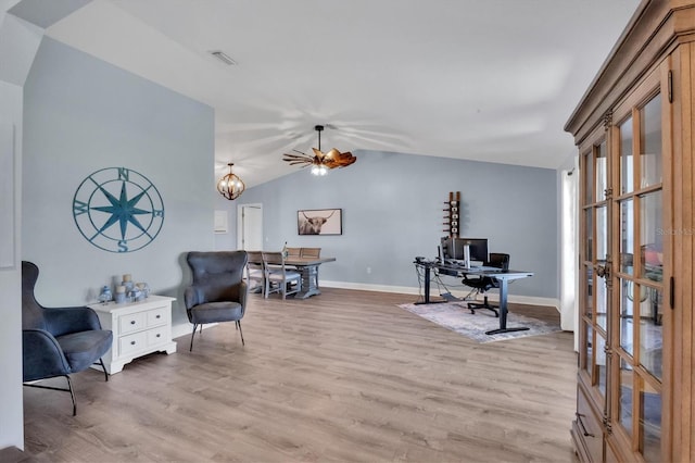 office area featuring lofted ceiling, light wood-style floors, visible vents, and baseboards