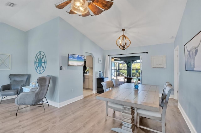 dining space featuring vaulted ceiling, baseboards, visible vents, and light wood-style floors