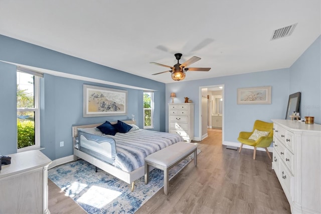 bedroom featuring light wood-style flooring, multiple windows, and visible vents