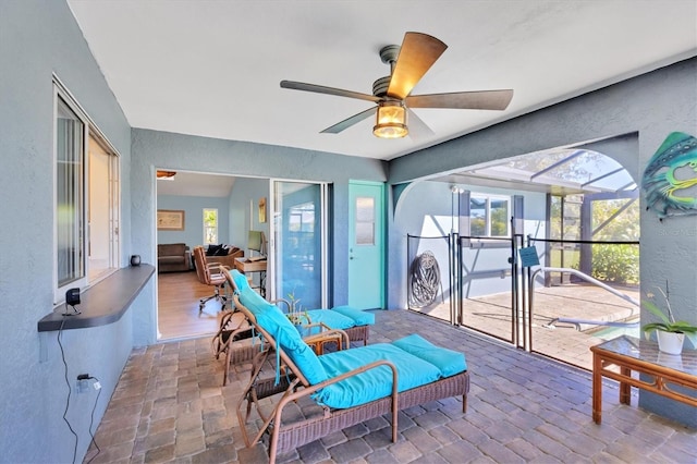 interior space with a ceiling fan, a lanai, and outdoor lounge area