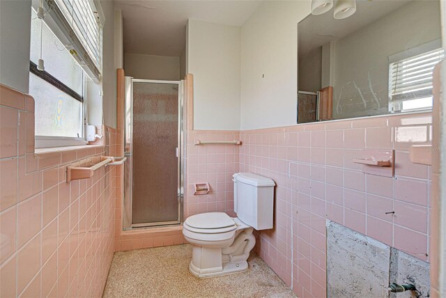 bathroom featuring tile walls, toilet, and walk in shower