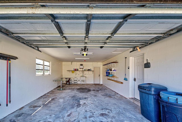 garage with a garage door opener and sink