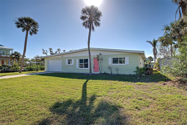 view of front of property featuring a garage and a front lawn