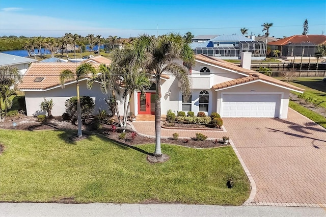 mediterranean / spanish-style home with a front yard and a garage