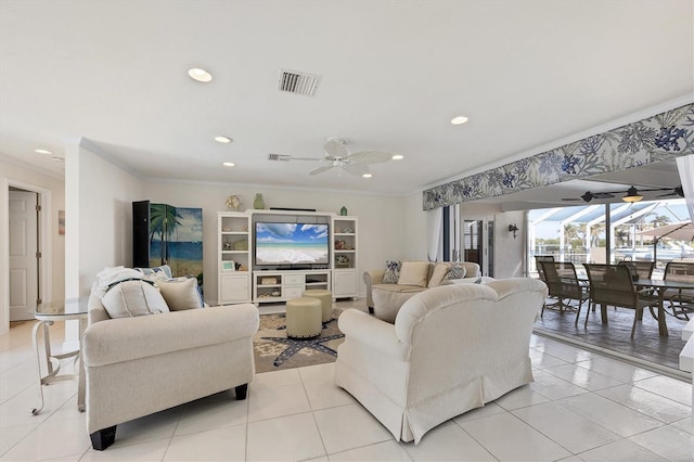 living room with ceiling fan, crown molding, and light tile patterned floors